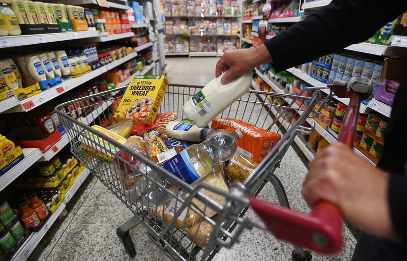 A shopper pushes a food trolley through a supermarket in central London. EPA