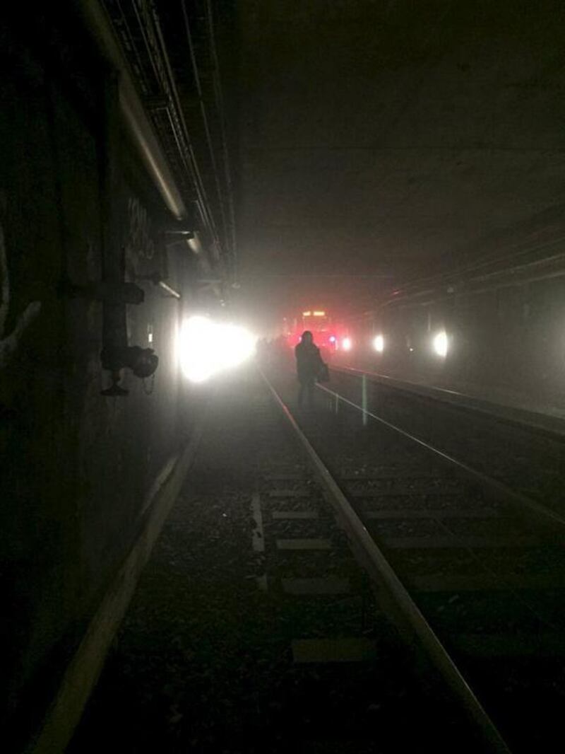 Passengers walk on underground metro tracks to be evacuated after an explosion at Maalbeek train station in Brussels, Belgium. Courtesy @OSOSXE via Twitter / Handout via Reuters