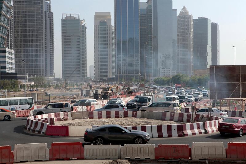 Dubai, United Arab Emirates - September 10, 2013.  Traffic building up as early as 8:30 am in this small temporary roundabout at the back of the JLT towers but slowly improving due to securities or traffic enforcers around the area, road construction in JLT is still ongoing.   ( Jeffrey E Biteng / The National )  Editor's Note;  Caline M reports. *** Local Caption ***  JB100913-Traffic08.jpg