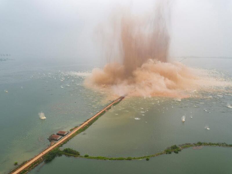 A dike between two lakes is seen under demolition in Wuhan, Hubei Province, China. China Daily via Reuters