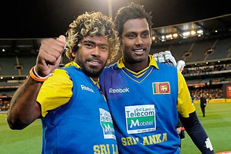 Lasith Malinga, left, and Angelo Mathews celebrate at the end of the first ODI against Australia.