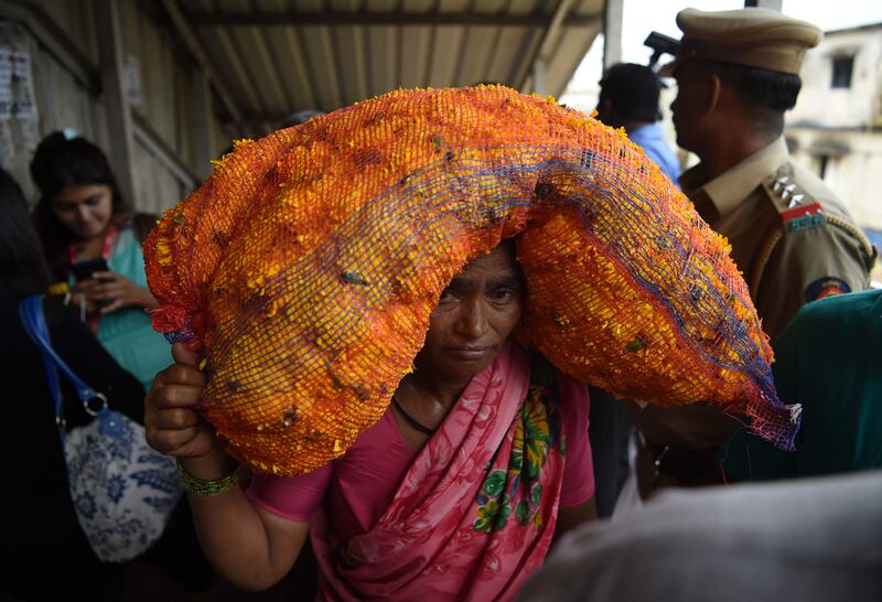 An Indian pedestrian carries flowers through the scene of a stampede on a railway bridge in Mumbai. AFP