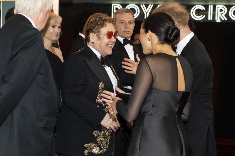 Prince Harry and Meghan, Duchess of Sussex chat with Elton John as they attend the premiere of Disney's 'The Lion King' in London's Leicester Square on July 14, 2019. AFP