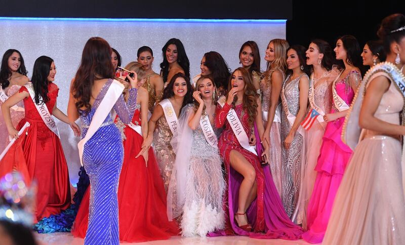 Miss World contestants take photos during the Miss World 2019 final in the Excel centre in London. EPA