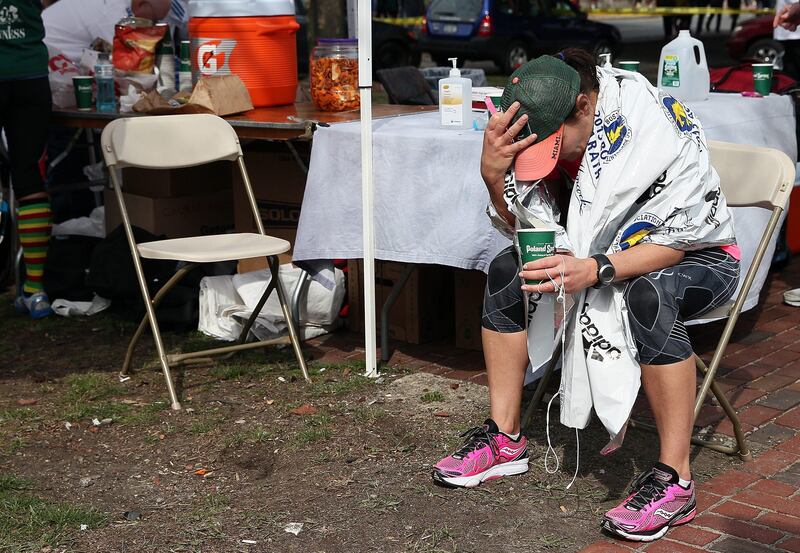 BOSTON, MA - APRIL 15: A runner sits near Kenmore Square after two bombs exploded during the 117th Boston Marathon on April 15, 2013 in Boston, Massachusetts. Two people are confirmed dead and at least 23 injured after two explosions went off near the finish line to the marathon.   Alex Trautwig/Getty Images/AFP== FOR NEWSPAPERS, INTERNET, TELCOS & TELEVISION USE ONLY ==
 *** Local Caption ***  917990-01-09.jpg