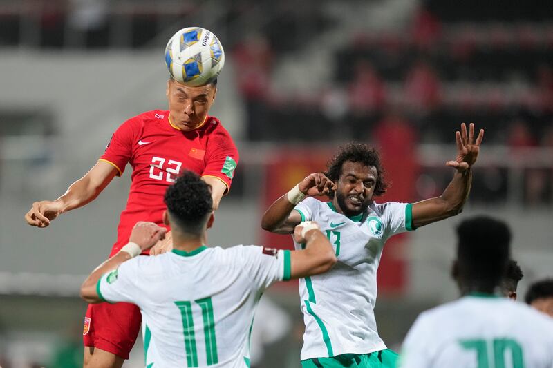 China's Dabao Yu heads the ball during the World Cup 2022 qualifier against Saudi Arabia in Sharjah. AP