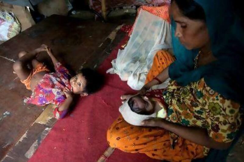 Gira, a Pakistani Hindu, with son Bharat, who was born in India, and Pakistan-born daughter Ram Gori in their temporary shelter in New Delhi.