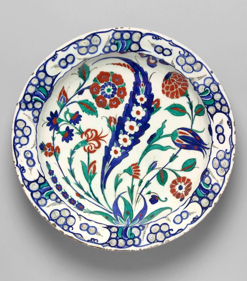  A 16th-century ceramic Iznik dish with a blue saz leaf, dotted tulips and roses. will be a part of the Cartier, Islamic Inspiration and Modern Design exhibition. Photo: Department of Culture and Tourism Abu Dhabi