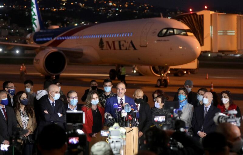 Health Minister Hamad Hassan speaks to media near the aircraft that brought the first batch of the Pfizer/BioNTech vaccine doses on Saturday. Reuters