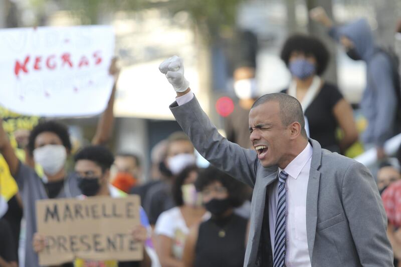 A protester raises his fist in the streets of Sao Goncalo during a protest amidst the coronavirus (COVID-19) pandemic in Sao Goncalo, Brazil. About 300 people walked and shouted slogans against the government of Jair Bolsonaro and protested against the death of the American George Floyd and the boy Joao Pedro (murdered by police in the Salgueiro community). The protesters were sympathizers of the "All Against Racism Movement" and "Black Lives Matter." Getty