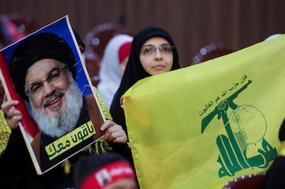 A woman carries a Hezbollah flag and a picture of leader Hassan Nasrallah at a rally marking Quds Day in Beirut. Reuters