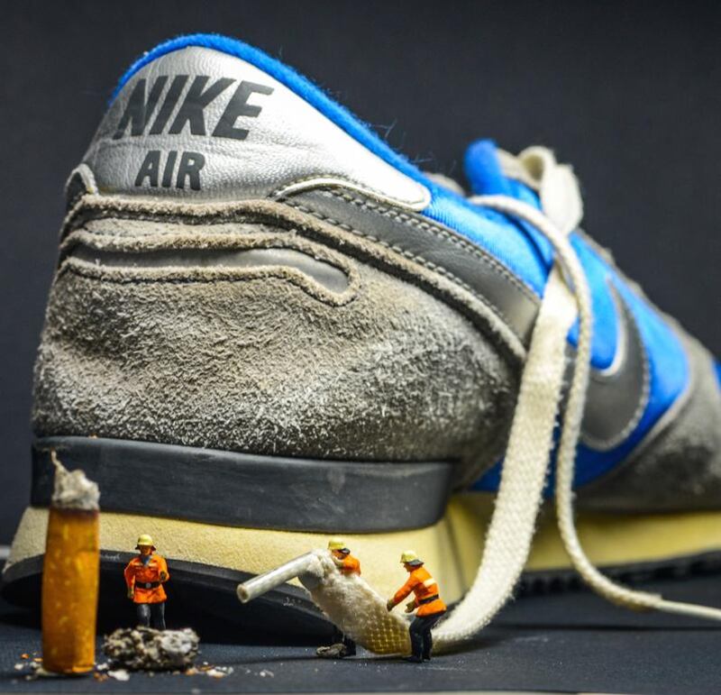 Firemen put out a fire with the lace of a Nike trainer. The image is anti-smoking with a caption reading - "take a breath of fresh air with Nike". Courtesy Omar Maree Humaid