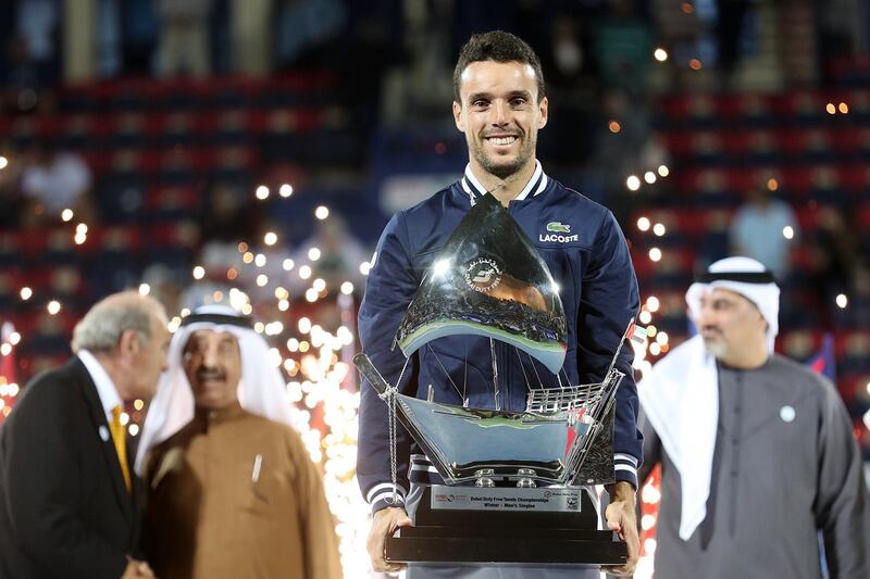 epa06577578 Roberto Bautista Agut of Spain raises the trophy after winning the Men's Singles Final match against Lucas Pouille of France in the ATP Dubai Duty Free Tennis Championships in Dubai, United Arab Emirates, 03 March 2018.  EPA/MAHMOUD KHALED