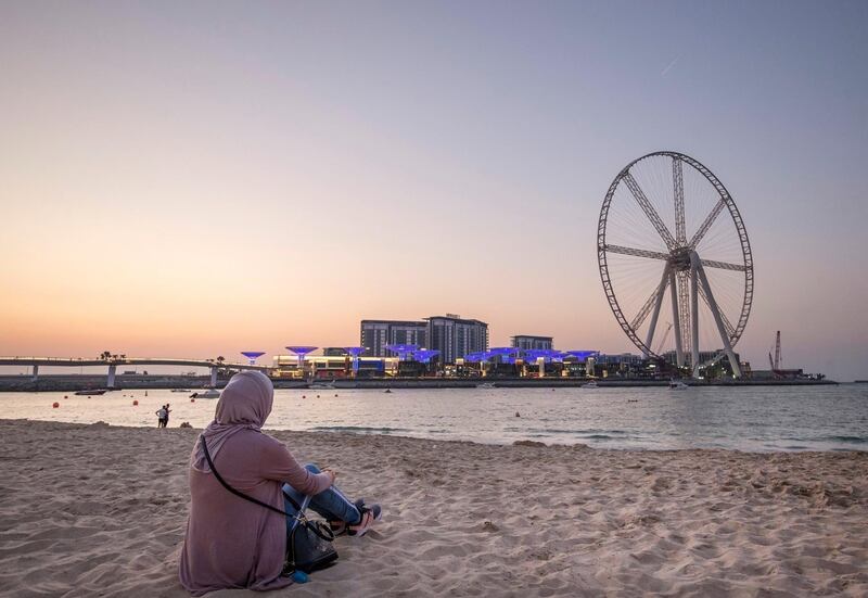 DUBAI, UNITED ARAB EMIRATES - A visitor at The Beach enjoying the weather and the view of BlueWaters from The Beach, Jumeirah Beach Residence, Dubai.  Leslie Pableo for The National