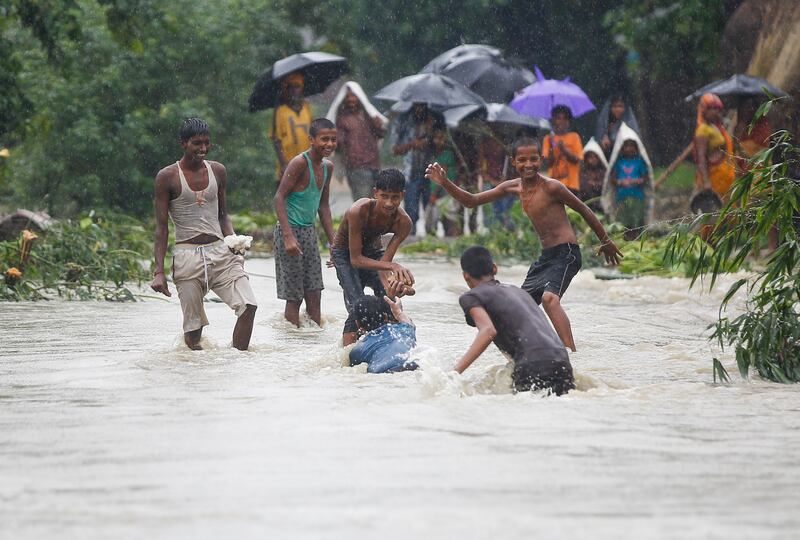 Young people play in flood water at Topa village in Saptari district, Nepal. Narendra Shrestha / EPA