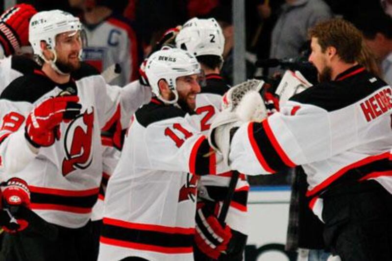 New Jersey Devils players celebrate their 5-3 win over the New York Rangers.