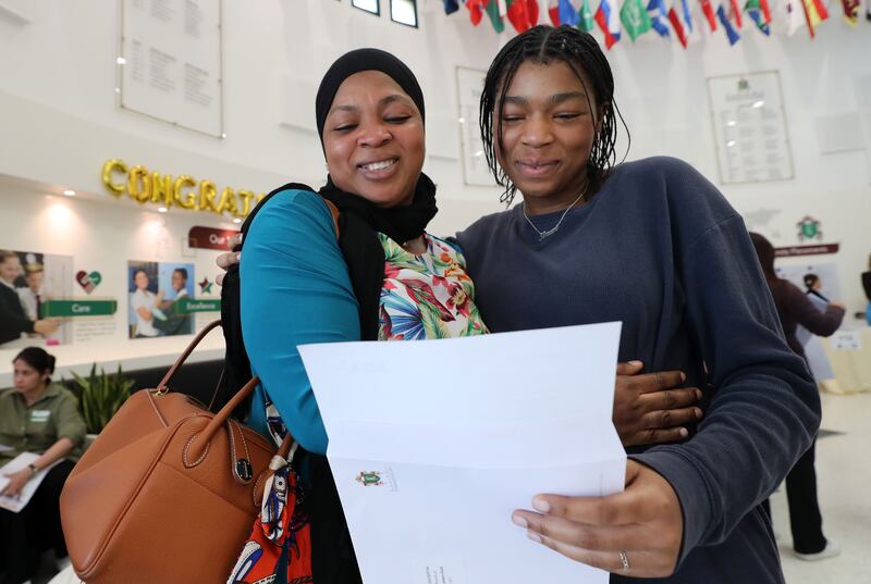 Ikram Alabi, right, receives her grades