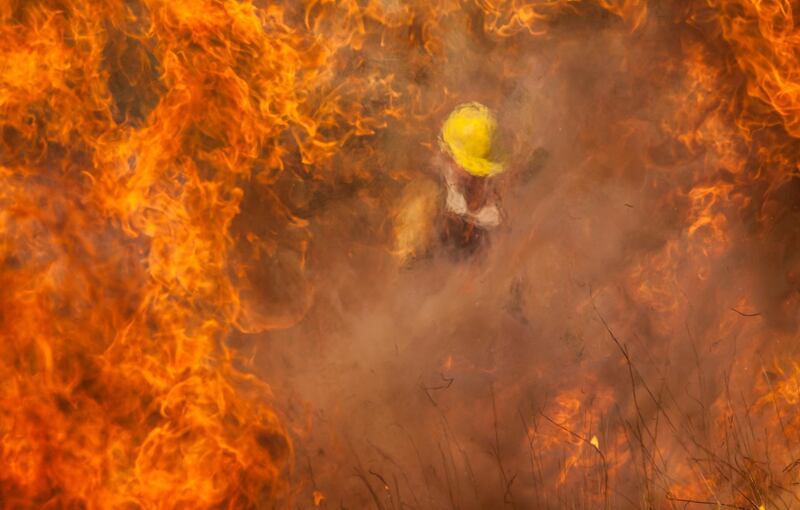 A firefighter battles flames in Capilla del Monte, Cordoba, Argentina.  AP Photo