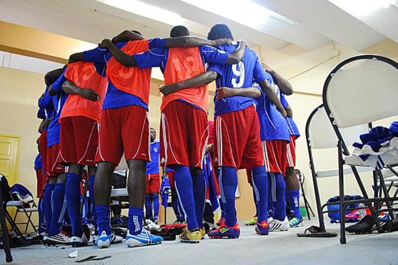 Haitian players in their dressing room huddle before the match.