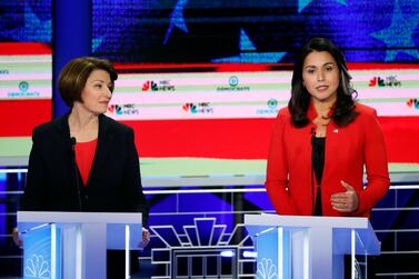 Democratic presidential candidate Rep. Tulsi Gabbard, D-Hawaii, speaks during a Democratic primary debate hosted by NBC News at the Adrienne Arsht Center for the Performing Art, Wednesday, June 26, 2019, in Miami, as Sen. Amy Klobuchar, D-Minn., listens at left. (AP Photo/Wilfredo Lee)