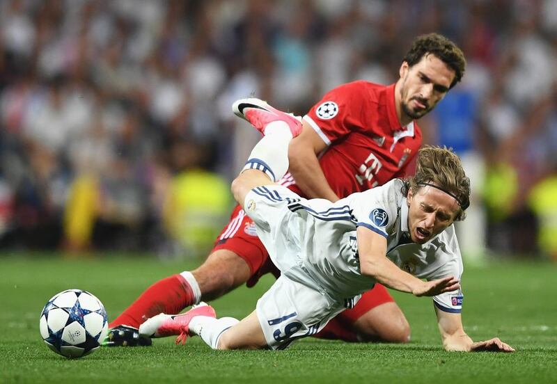 Luka Modric of Real Madrid is challenged by Mats Hummels of Bayern Munich. Shaun Botterill / Getty Images