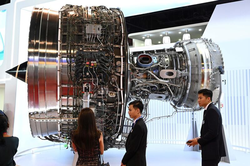 Visitors look at the Rolls Royce Trent XWB engine displayed during the Singapore Airshow in Singapore on February 12, 2020. (Photo by Roslan RAHMAN / AFP)