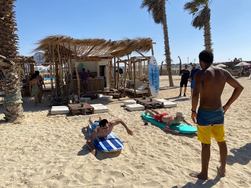 Thibaut and Lixue Wan learning to surf on shore. Nada El Sawy / The National