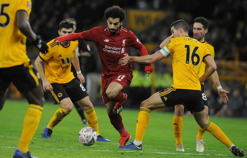 Mohamed Salah competes for the ball with Wolverhampton's Conor Coady during the FA Cup third round. AP Photo