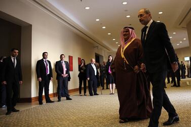 Bahraini Foreign Minister Khalid bin Ahmed al-Khalifa (C) is received by his Jordanian counterpart Ayman Safadi pose (R) before the Ministerial Consultative meeting held in the Dead Sea. EPA