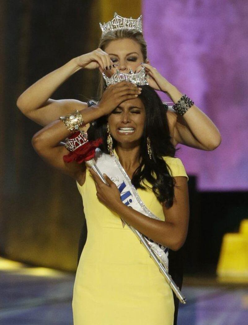 Miss New York Nina Davuluri, front, is crowned as Miss America 2014 by Miss America 2013 Mallory Hagan in Atlantic City, N.J. AP Photo/Mel Evans