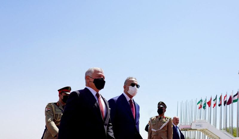 Iraqi Prime Minister Mustafa Al Kadhimi and King Abdullah of Jordan walk on the tarmac at Baghdad airport. AFP