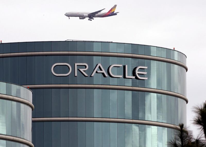 FILE - In this March 20, 2012, file photo, a plane flies over Oracle headquarters in Redwood City, Calif. On Tuesday, March 27, 2018, a federal appeals court overturned a decision in a long-running legal battle over whether Google infringed on Oracle's Java programming language to build its hugely popular mobile operating system, Android. (AP Photo/Paul Sakuma, File)