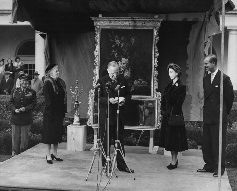 Princess Elizabeth and Prince Philip, the Duke of Edinburgh, smiling as President Harry Truman  gives a speech and his aide, General Harry Vaughan (extreme left) looks on, in Washington DC, November 5th 1951. (Photo by Fox Photos/Hulton Archive/Getty Images)