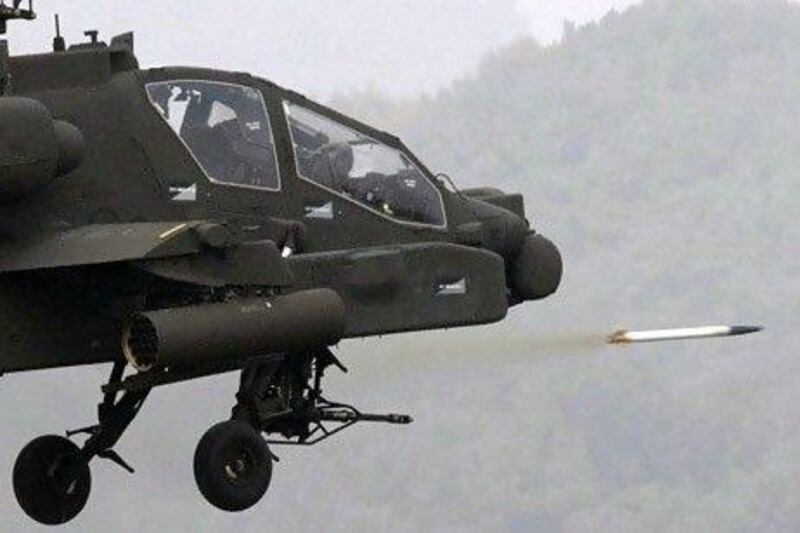 A US Apache helicopter fires a rocket during a military exercise. AP Photo