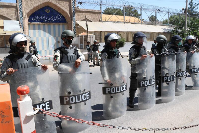Afghan riot police stand guard outside the Iranian consulate during a protest against the Iranian regime and demand justice for the Afghans allegedly killed by the Iranian security forces, in Herat, Afghanistan, on May 11, 2020. EPA
