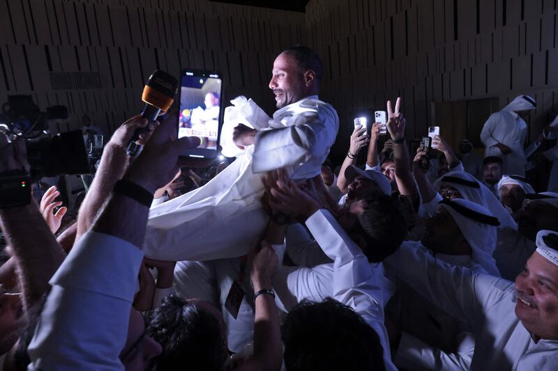 Kuwaiti MP Marzouq Al Ghanim celebrates with his supporters following the announcement of his re-election to the legislative assembly. AFP
