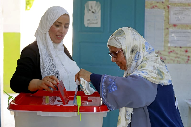 A Tunisian woman votes during a referendum on the draft constitution put forward by the country's president at a polling station in the Ben Arous region near Tunis. AFP