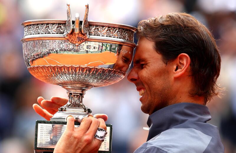 PARIS, FRANCE - JUNE 09: Rafael Nadal of Spain celebrates with the trophy following the mens singles final against Dominic Thiem of Austria during Day fifteen of the 2019 French Open at Roland Garros on June 09, 2019 in Paris, France. (Photo by Clive Brunskill/Getty Images)