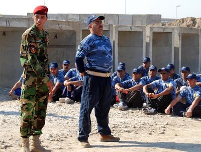 An Iraqi police instructor explains a drill to new recruits. Photo: US Army