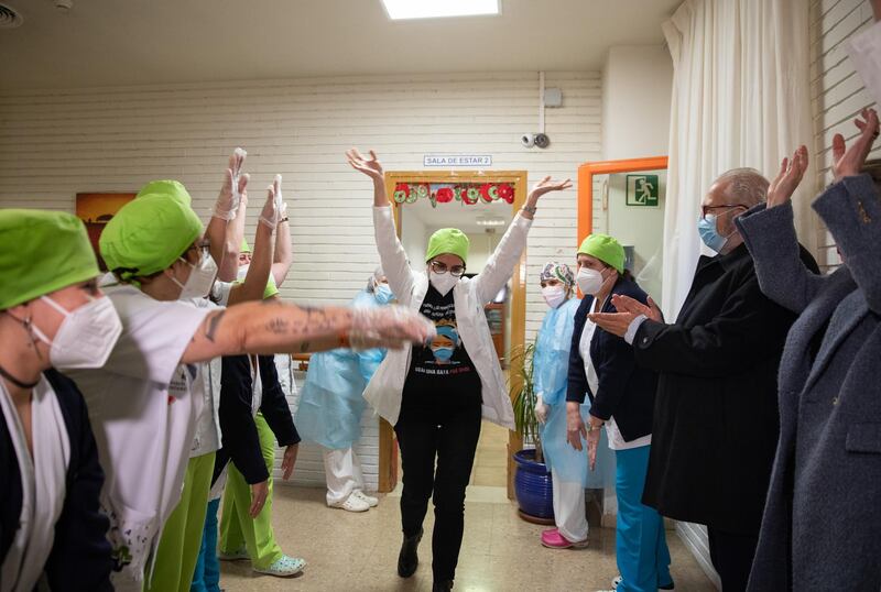 BARBASTRO, SPAIN - DECEMBER 27: Maria Carmen CortÃ©s, 45, a nurse at the Somontano residence and several health workers celebrate moments after receiving one of the first Pfizer/BioNTech Covid-19 vaccines in Spain on December 27, 2020 in Barbastro, Spain. Spain will begin to administer the coronavirus vaccine developed by Pfizer and BioNTech on December 27. With 1.84 million cases recorded since the start of the pandemic, Spain has reported almost 50,000 covid-19 deaths. (Photo by Alvaro Calvo/Getty Images) ***BESTPIX***