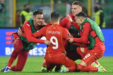 Goal scorer North Macedonia 's forward Aleksandar Trajkovski (C) celebrates with teammates at the end of the 2022 World Cup qualifying play-off football match between Italy and North Macedonia, on March 24, 2022 at the Renzo-Barbera stadium in Palermo.  (Photo by Alberto PIZZOLI  /  AFP)