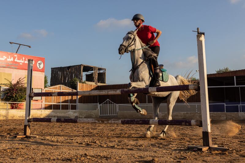 A teenager practises showjumping at Friends Equestrian Club.