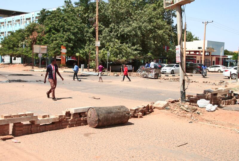 Sudanese anti-coup protesters use bricks to barricade a street in the capital Khartoum. The military takeover came after weeks of mounting tensions between military and civilian leaders over the course and the pace of Sudan's transition to democracy. AFP