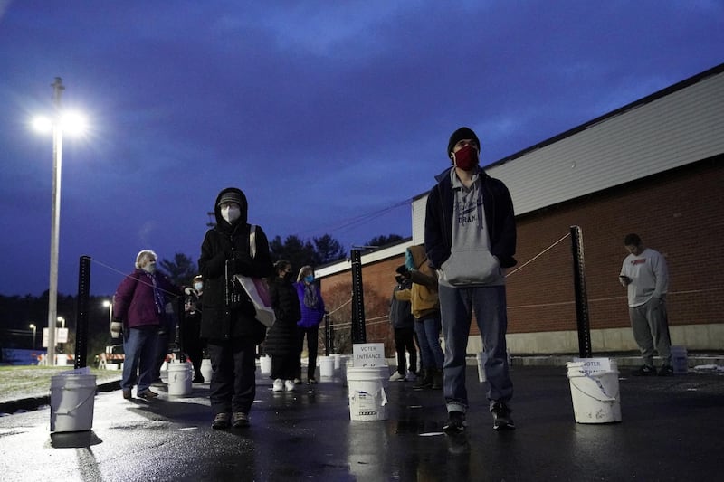 Voters queue at the Waterville Junior High School polling station before doors open on the election day in Waterville, Maine. Reuters
