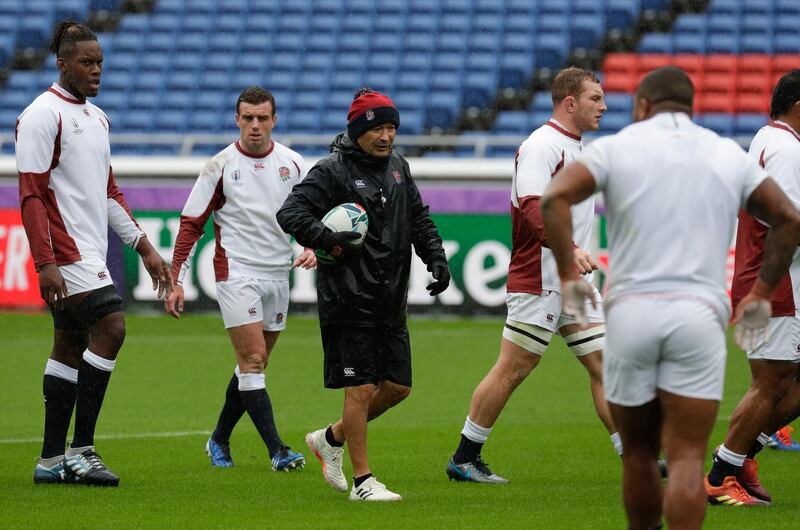 England rugby team coach Eddie Jones, center, gives instructions during training at the Yokohama International Stadium in Yokohama, Japan on Friday Oct. 25, 2019. England will face New Zealand in the Rugby World Cup semifinals on Oct. 26. (AP Photo/Aaron Favila)