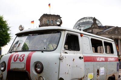 A Ukrainian ambulance, on display in Germany, is show with dozens of holes from a cluster bomb attack in Ukraine. AP