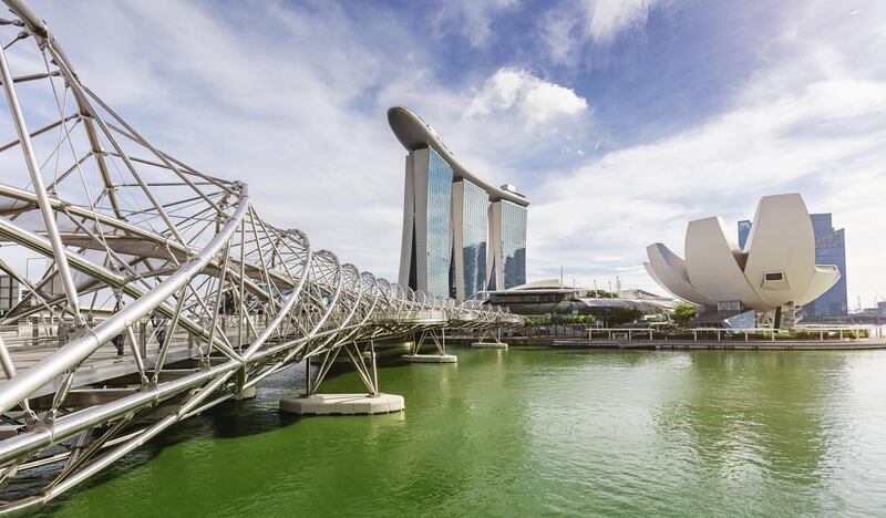 Panoramic view of Marina Bay Area Cityscape with Marina Sands Hotel (small in the middle) and  the ArtScience Museum of Singapore on the right side. Part of the the pedestrian helix bridge, a structure of glass and stainless steel on the left side of the panorama.