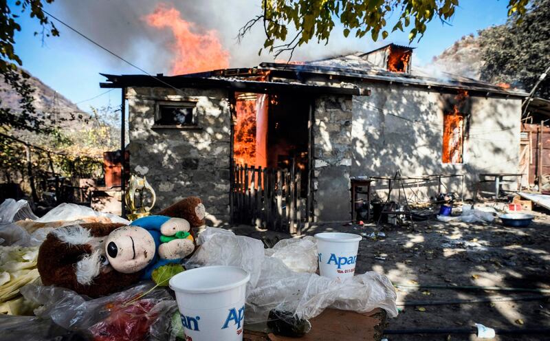 A house burns in the village of Charektar outside the town of Kalbajar . Villagers in Nagorno-Karabakh set their houses on fire before fleeing to Armenia.  AFP