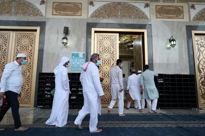 People arrive at Al Farooq Omar Bin Al Khattab Mosque for morning prayers on Eid Al Adha. Jumeirah, Dubai. Chris Whiteoak / The National