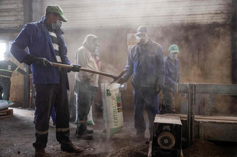 Workers fill bags with fertiliser in the Elephant Vert factory in the 'Agropolis' industrial zone in Morocco's northern city of Meknes. AFP
